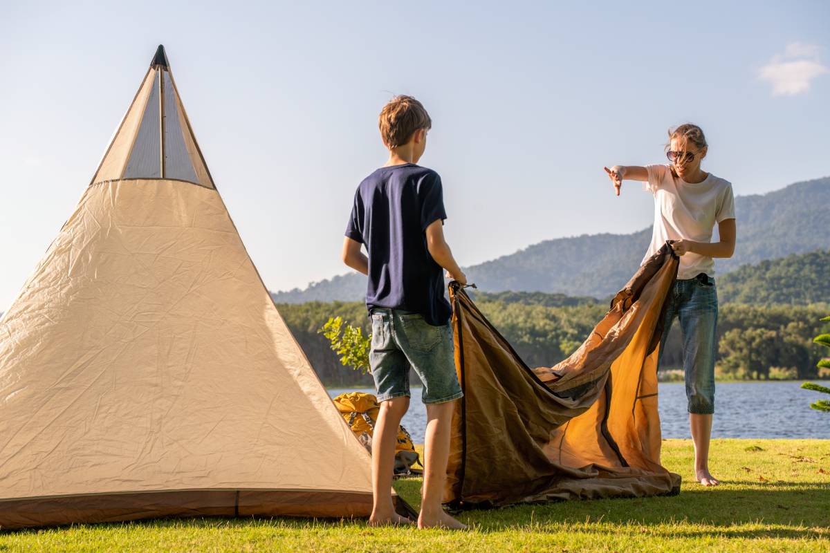 family-setting-up-a-tent-camping-on-a-grassy-overl-2024-11-21-23-21-21-utc (1)