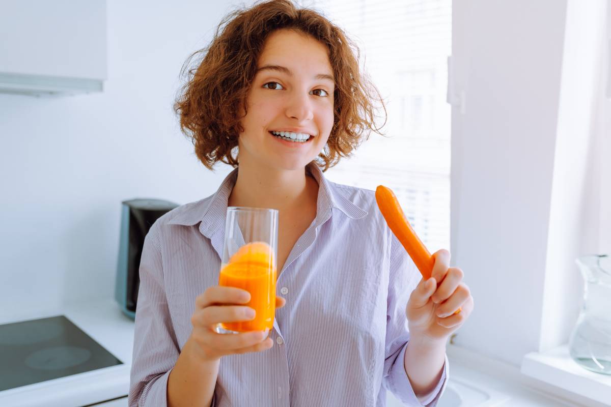 young-woman-drinks-vitamin-carrot-juice-in-morning-2023-11-27-05-09-40-utc (1)
