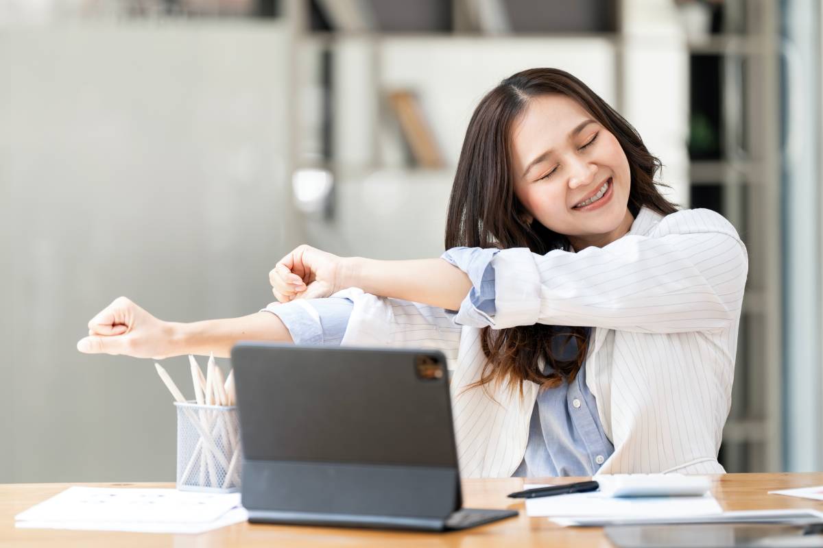 happy-woman-sitting-in-her-office-with-a-laptop-in-2024-12-06-09-40-36-utc (1)