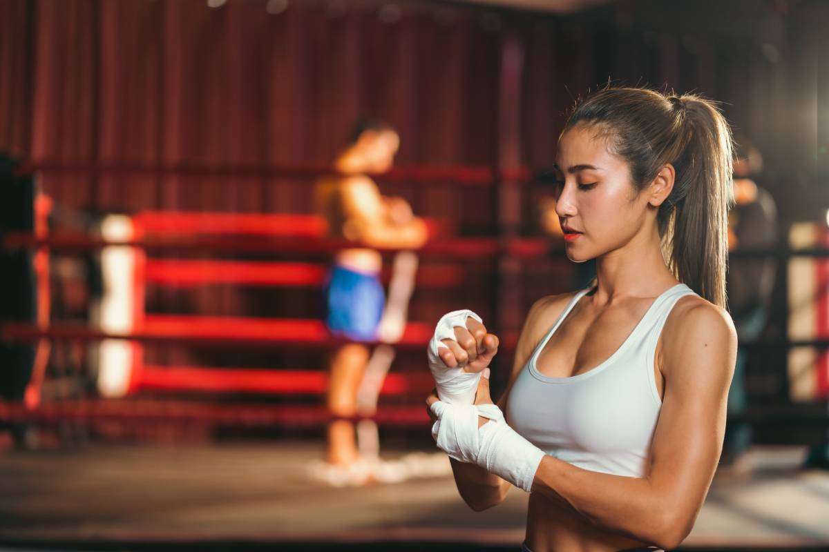 Asian woman training kick boxing with punching glove, fitness woman with physical exercising
