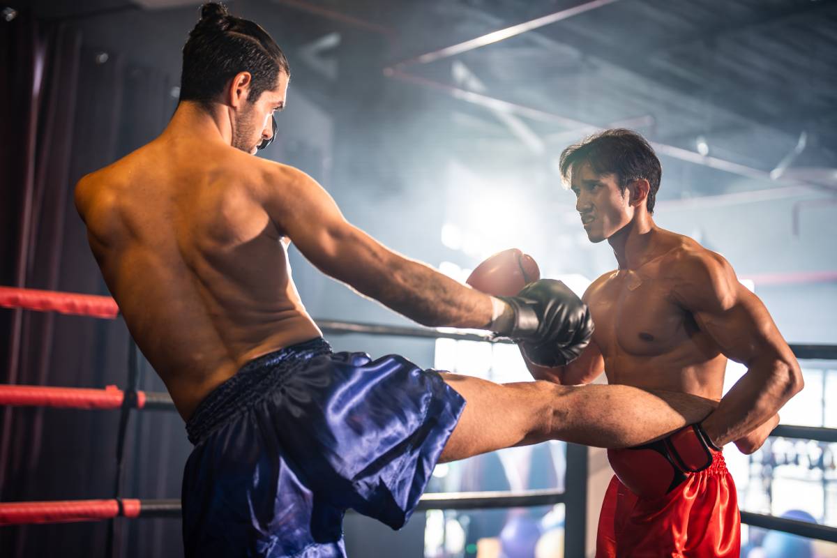 Two young professional boxer having a competition tournament on stage. Attractive male athlete fighters muscular shirtless punches and hitting competitor enjoy boxing exercise in the ring at stadium.
