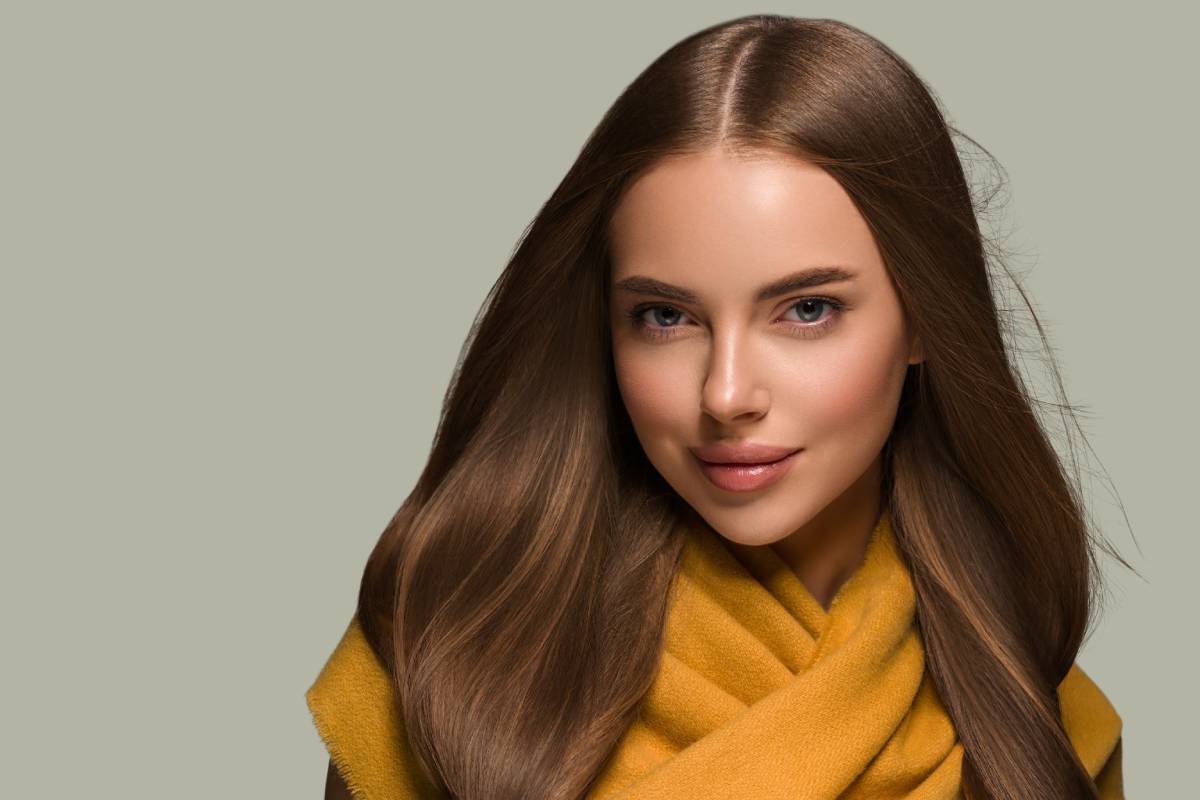 Woman in knit clothes yellow autumn winter style long hair. Color background green